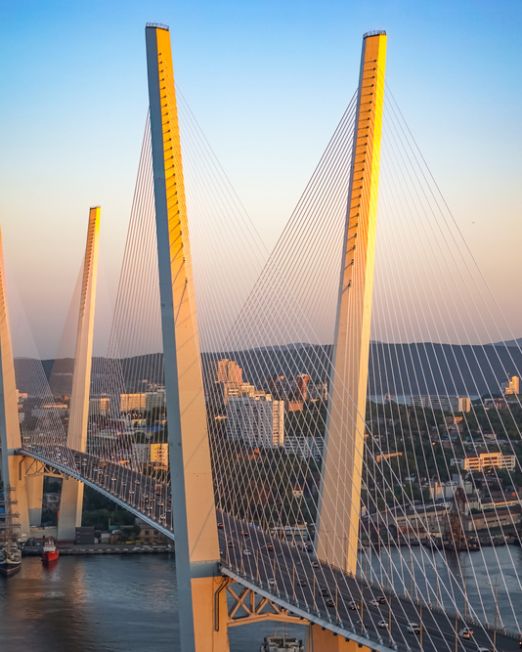 Golden bridge is a landmark of the city at sunset.